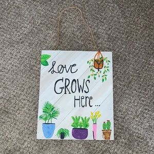 Love grows here wall decor sign